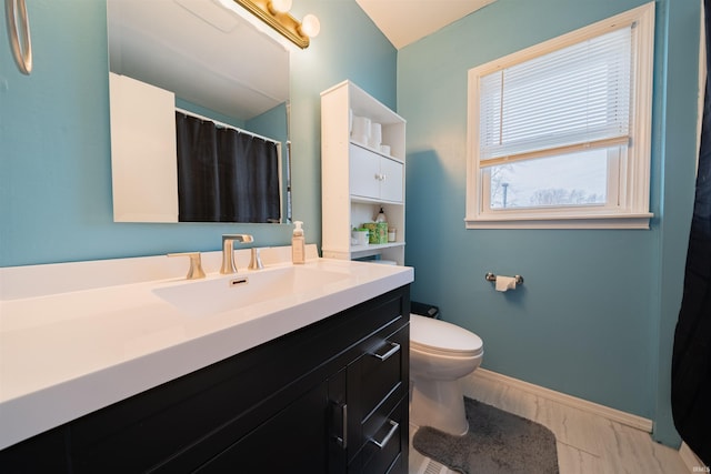 bathroom featuring vanity and toilet