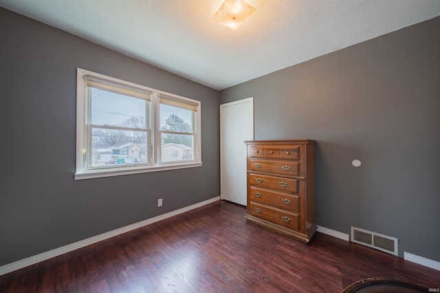 unfurnished bedroom featuring dark wood-type flooring