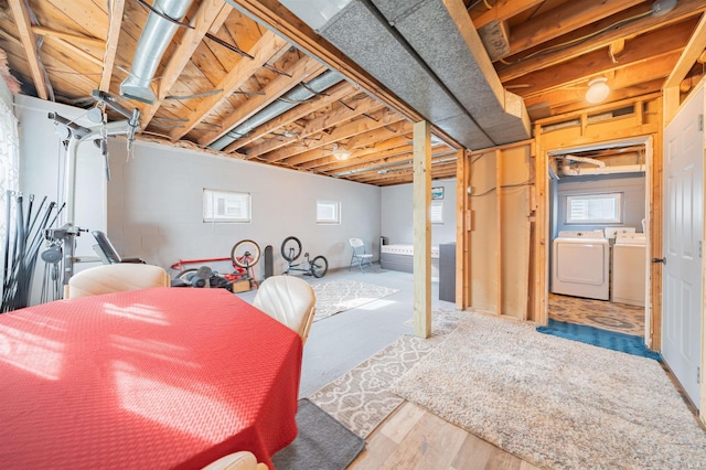 basement featuring hardwood / wood-style flooring and independent washer and dryer