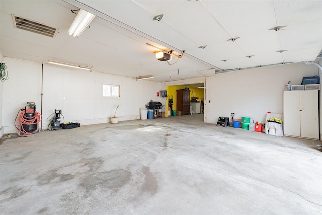 garage featuring washer / clothes dryer and a garage door opener