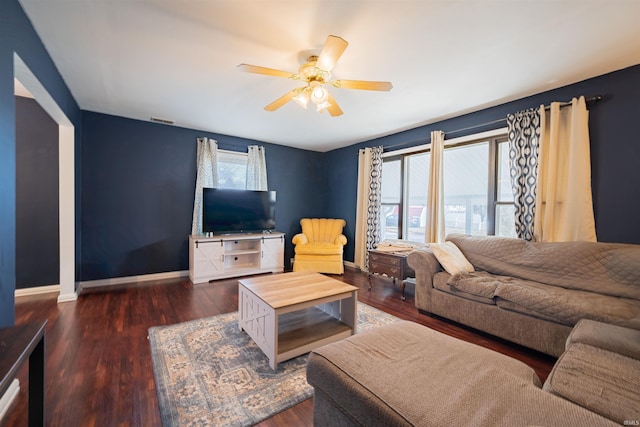 living room featuring ceiling fan, a healthy amount of sunlight, and dark hardwood / wood-style floors