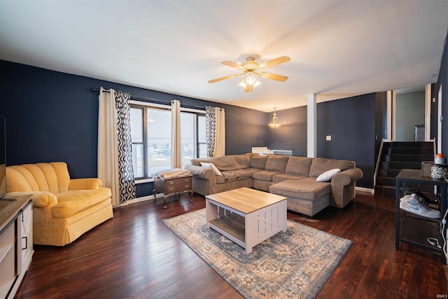 living room with dark hardwood / wood-style flooring and ceiling fan