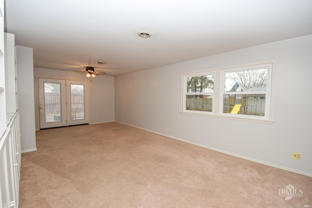 carpeted spare room with ceiling fan