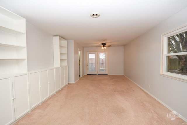 empty room featuring light colored carpet and ceiling fan