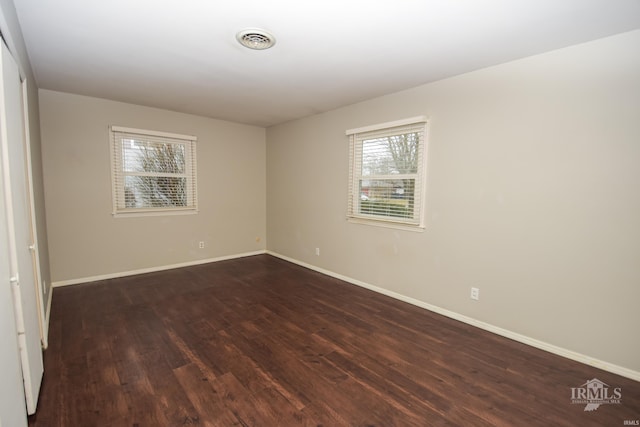 spare room featuring dark wood-type flooring