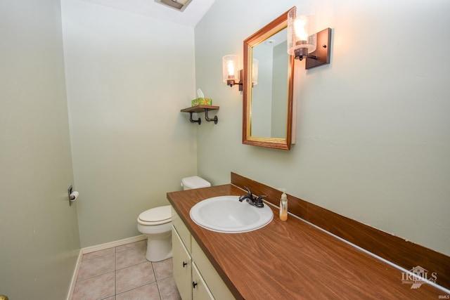 bathroom with tile patterned flooring, vanity, and toilet