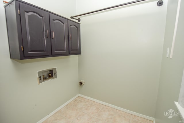 laundry area with cabinets, washer hookup, and light tile patterned floors