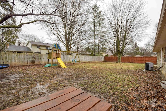 view of yard with cooling unit and a playground