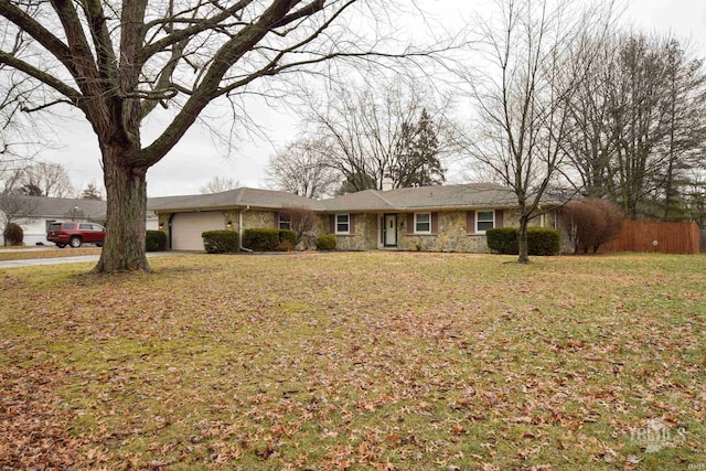 ranch-style home featuring a garage and a front yard