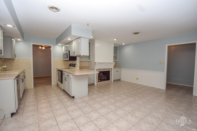 kitchen featuring white cabinets, light tile patterned floors, sink, and electric range