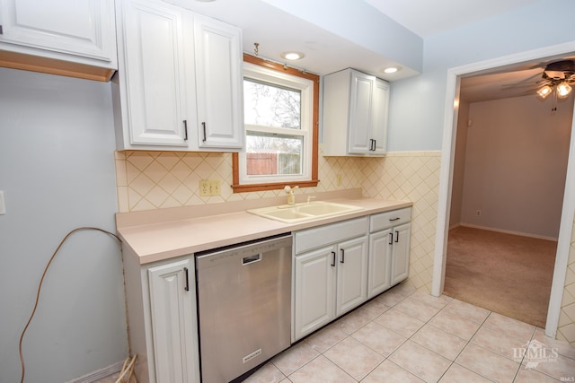 kitchen featuring white cabinetry, dishwasher, sink, and light tile patterned floors