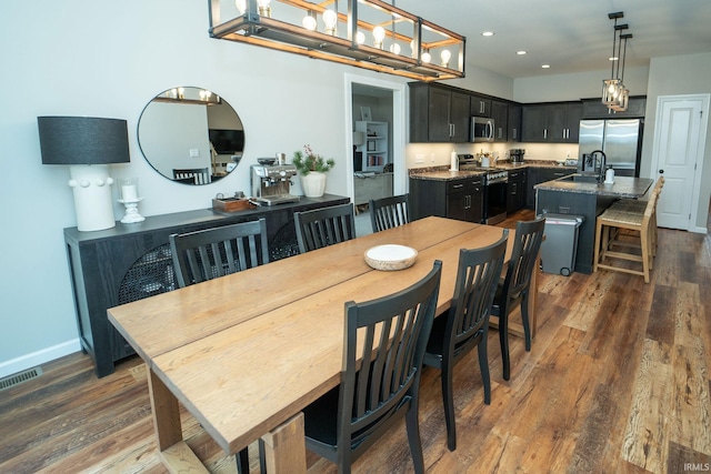 dining space with dark hardwood / wood-style flooring and sink