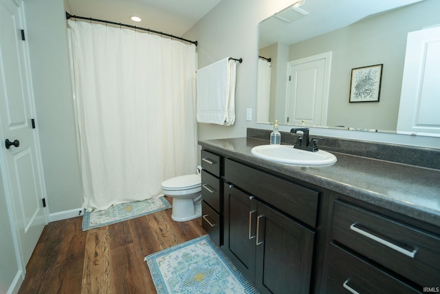 bathroom featuring vanity, toilet, and wood-type flooring