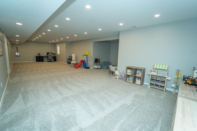 recreation room featuring light carpet
