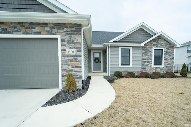 view of front of property featuring a garage and a front lawn