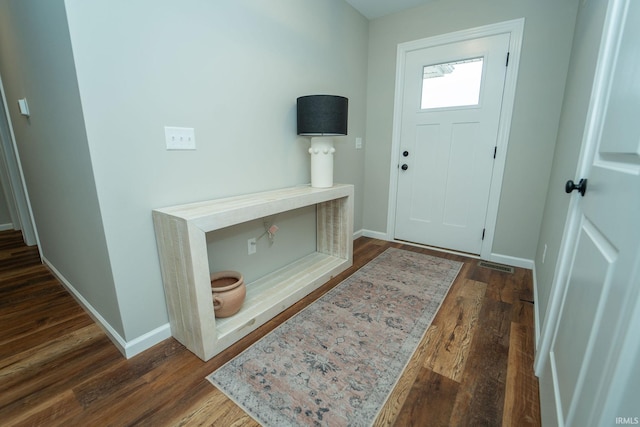 entryway with dark wood-type flooring