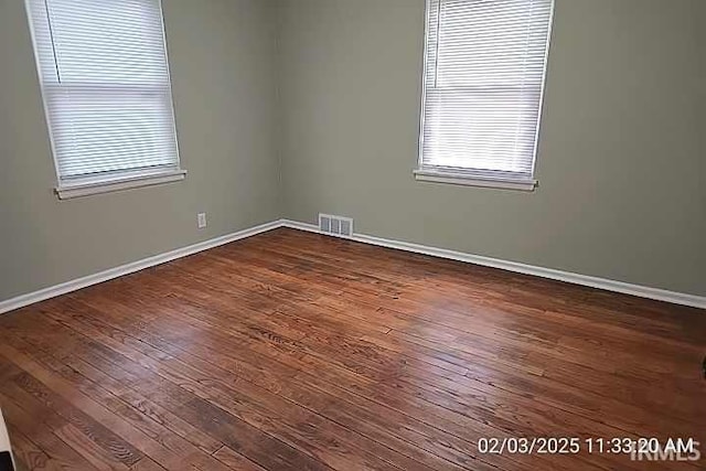 unfurnished room featuring dark hardwood / wood-style flooring