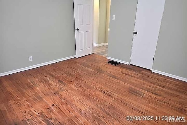 unfurnished bedroom featuring hardwood / wood-style floors and a closet