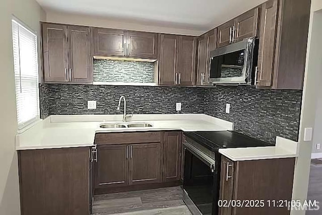 kitchen featuring stainless steel appliances, tasteful backsplash, sink, and dark brown cabinetry