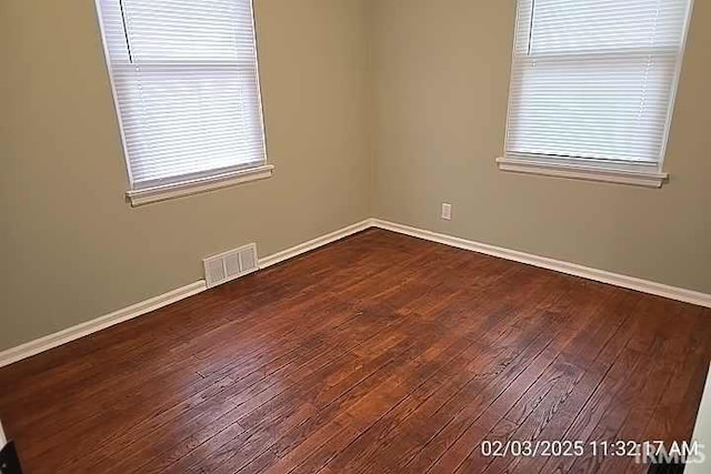 spare room with dark hardwood / wood-style floors