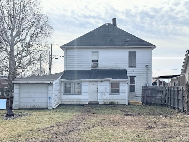 back of house featuring a lawn