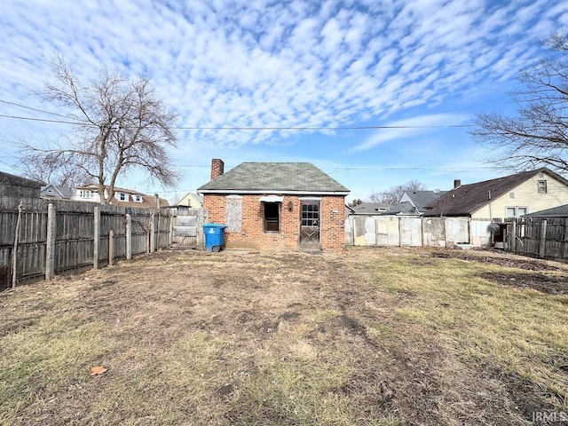 rear view of property featuring a yard