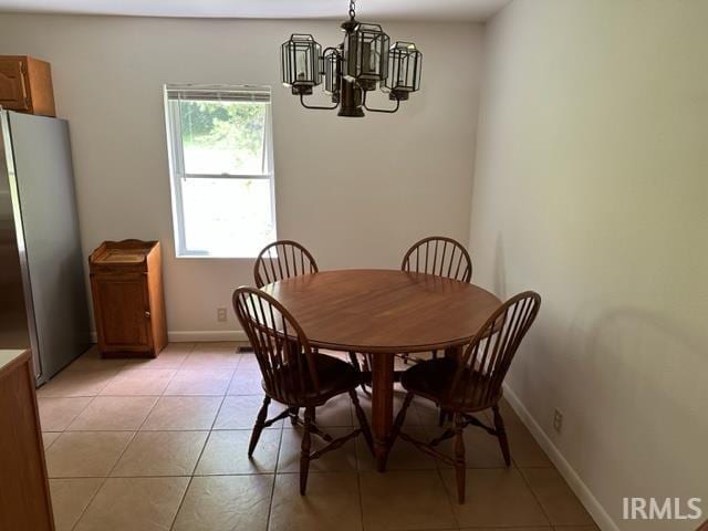 dining space with a chandelier and light tile patterned floors