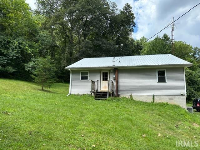 rear view of house with a yard