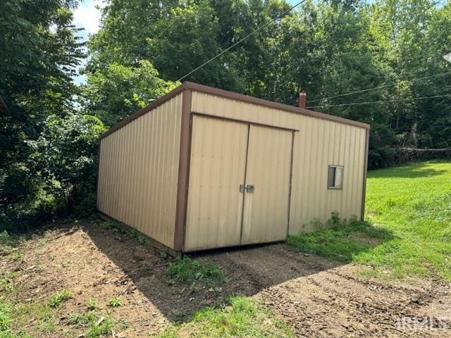 view of outbuilding featuring a yard