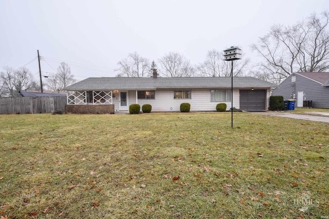 ranch-style house with central AC unit, a garage, and a front lawn