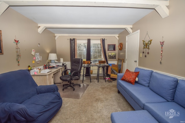 carpeted home office featuring lofted ceiling with beams