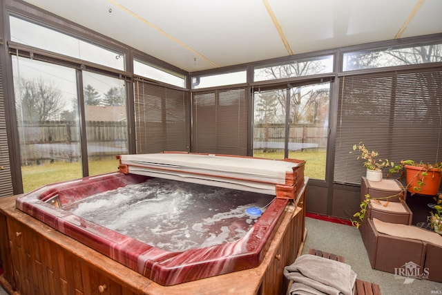 sunroom featuring a hot tub