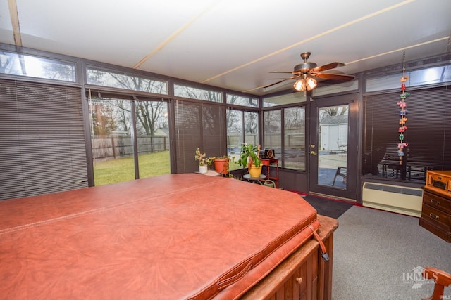 sunroom / solarium featuring ceiling fan and a wall mounted AC