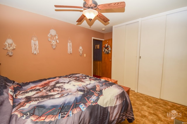 unfurnished bedroom with carpet, two closets, and ceiling fan