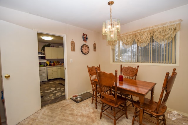 carpeted dining space with a notable chandelier