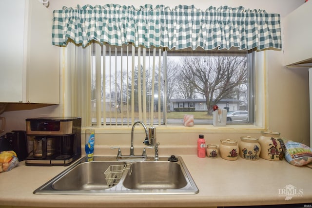 kitchen with white cabinetry and sink