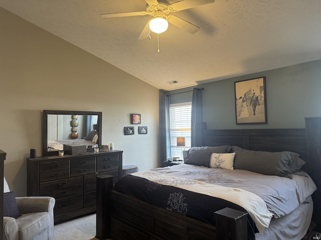 bedroom featuring ceiling fan, lofted ceiling, light carpet, and a textured ceiling