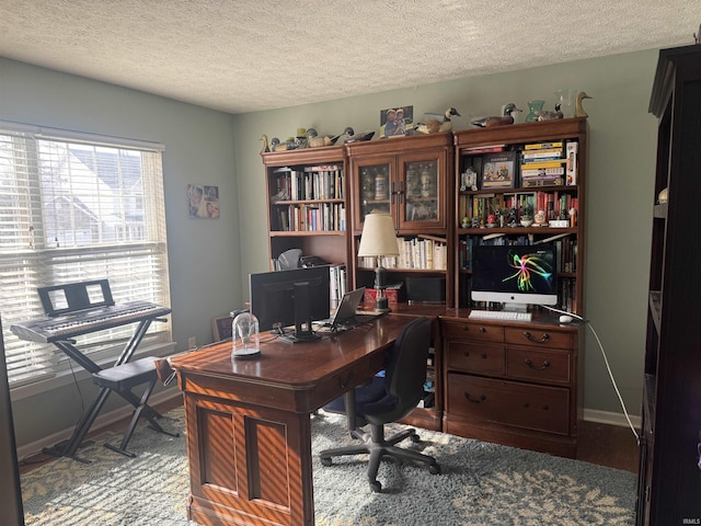 office area with a textured ceiling