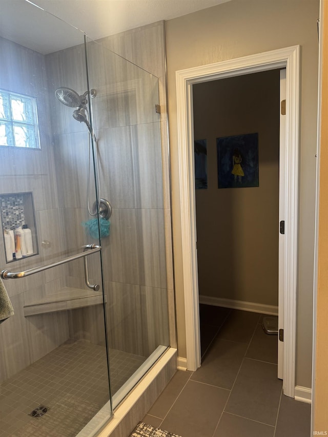 bathroom featuring an enclosed shower and tile patterned floors