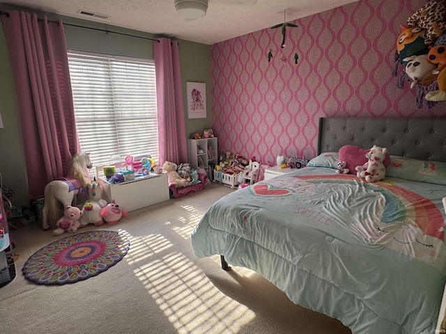 carpeted bedroom featuring a textured ceiling