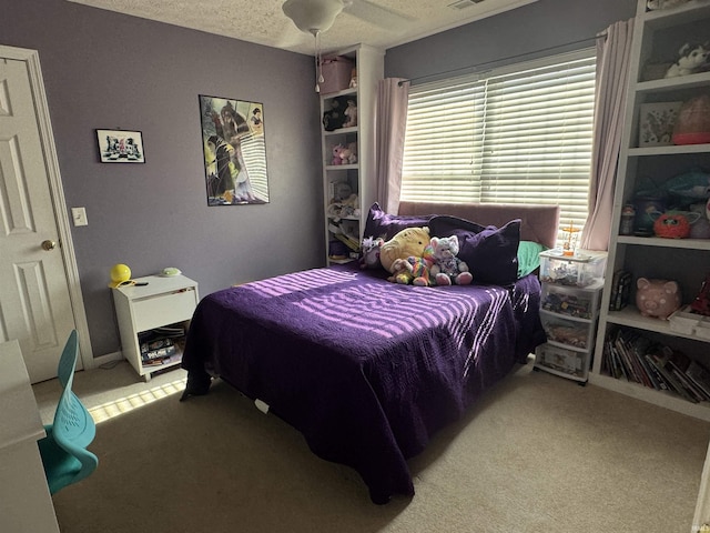 bedroom featuring light carpet and a textured ceiling