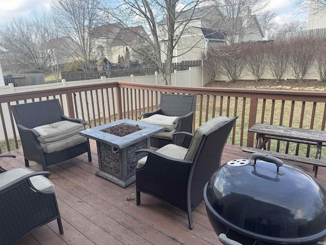 wooden terrace featuring an outdoor fire pit