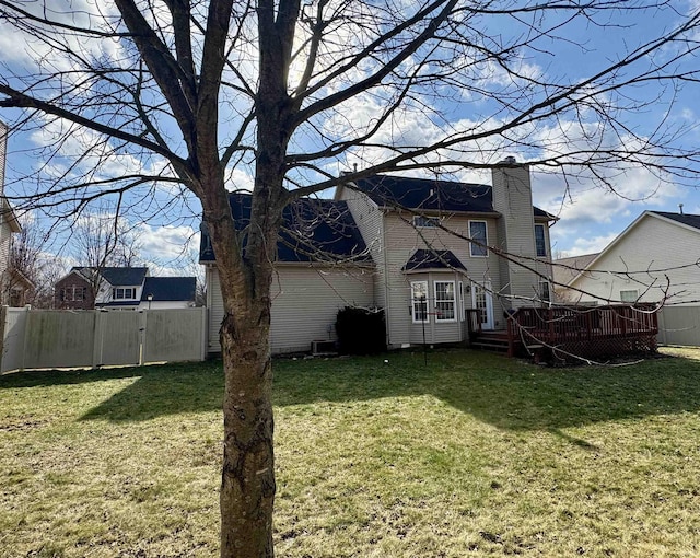 back of house with a yard and a deck