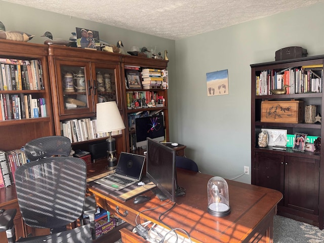 office area with a textured ceiling