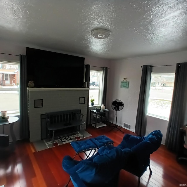 living room with hardwood / wood-style floors and a textured ceiling