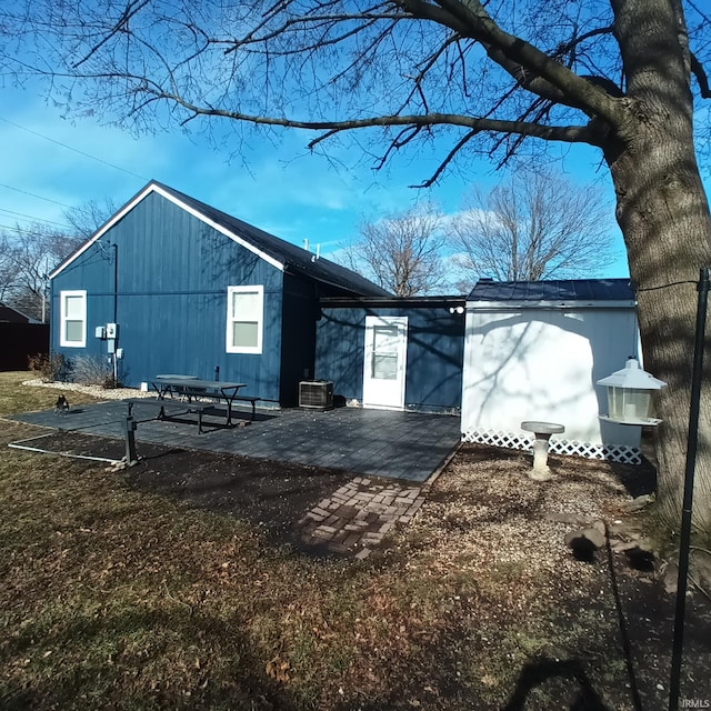 back of property featuring central AC unit and a patio area