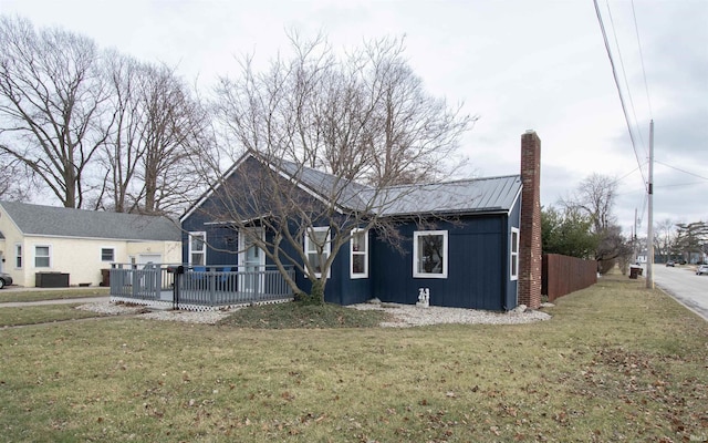 view of front of home with a front yard and central air condition unit