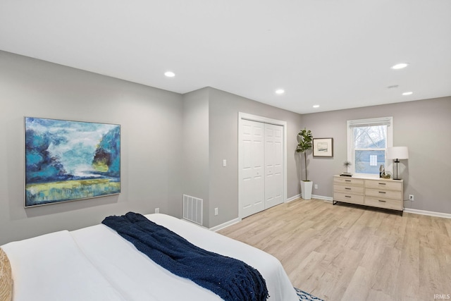 bedroom featuring light hardwood / wood-style floors and a closet