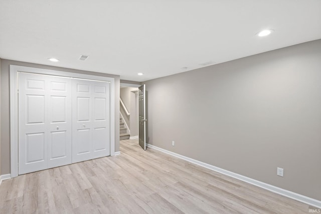 unfurnished bedroom featuring a closet and light wood-type flooring