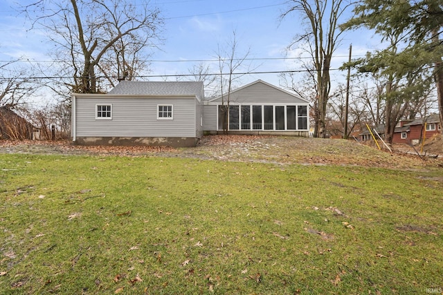 back of property featuring a sunroom and a yard